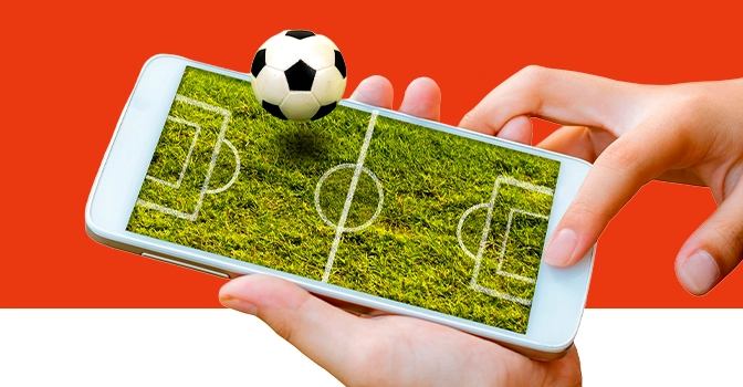 Imagem mostra celular com ilustração de um campo de futebol e uma bola saltando da tela